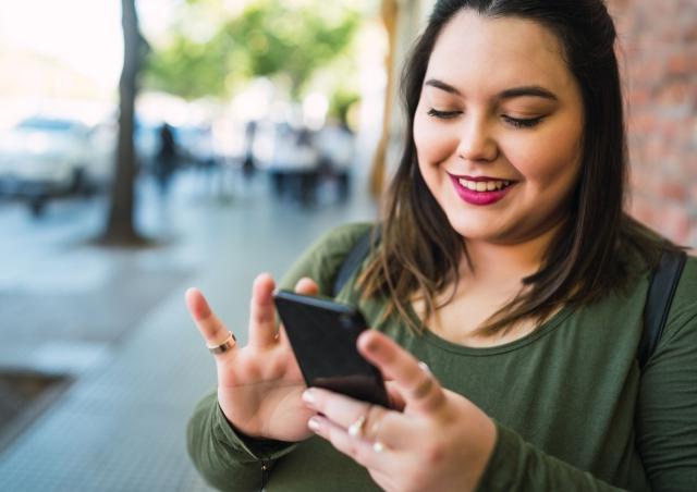 Woman checking her finances on her smart phone.